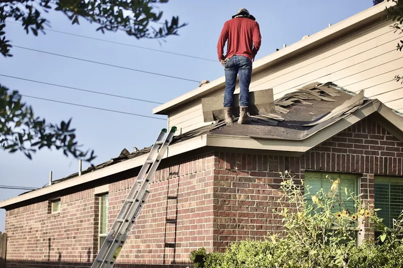 Professional roofer working on a residential roof in Palmetto Bluff